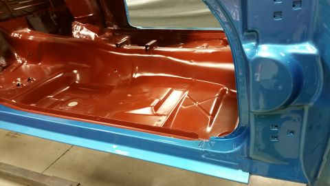1970 Pontiac Trans Am - Interior floor pan of a car, coated in red primer and blue paint. Supermotors.net logo is visible.
