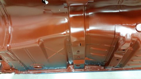 1970 Pontiac Trans Am - The underside of a vehicle, painted in a reddish-brown hue, reveals structural components and floor pan details.