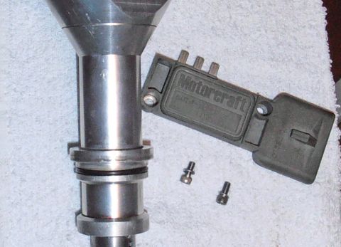 1990 Ford Bronco - A close-up shows a Motorcraft ignition module and a vehicle distributor component.