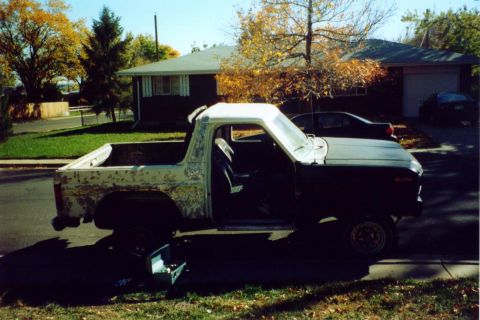1981 Ford Bronco - This 1981 Ford Bronco shows significant body wear and has its hood and doors open.