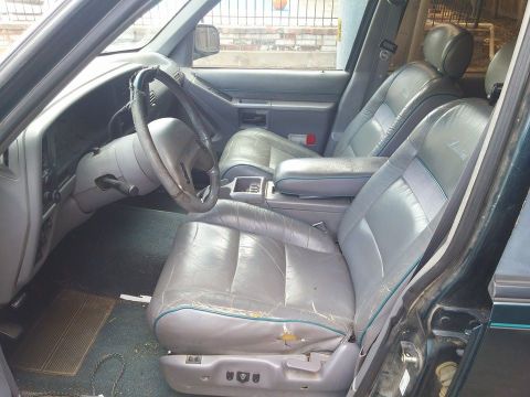 2000 Mercury Grand Marquis - The interior of this vehicle shows significant wear on the gray leather seats and dashboard.