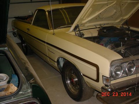 1971 Ford Ranchero - A cream 1971 Ford Ranchero is shown with its hood open, parked indoors next to another vehicle.