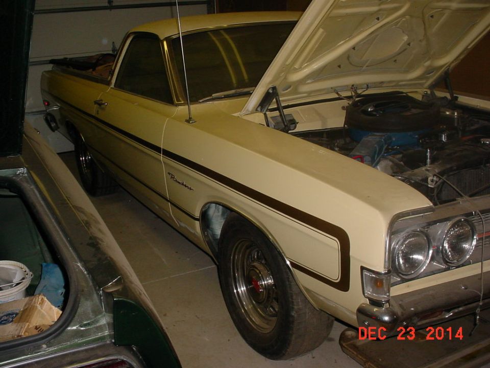 Cream 1971 Ford Ranchero with hood open, parked next to another vehicle