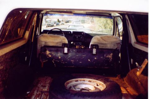 1981 Ford Bronco - Interior view of a vehicle, likely a 1980s Ford Bronco, with a spare tire visible in the cargo area.