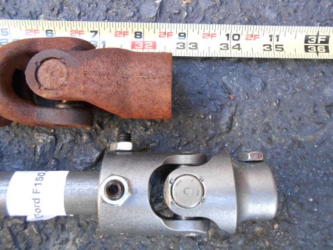 1992 Ford Bronco - Comparison of a rusty universal joint with a new steering shaft, possibly for a Ford F150.