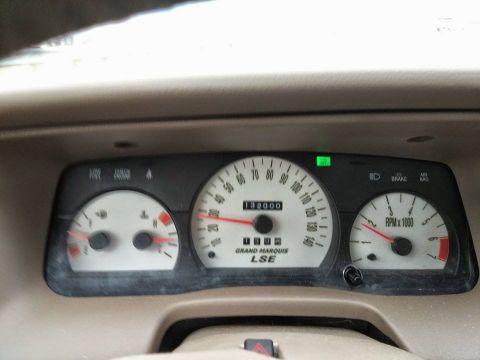 2000 Mercury Grand Marquis - The dashboard gauges of a vehicle show the odometer reading and other indicators.