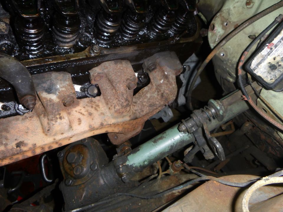 Engine exhaust manifold and steering column components in a vehicle