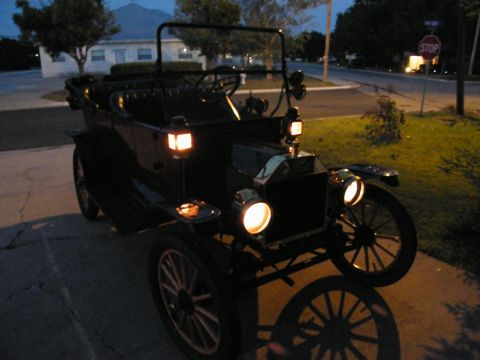 1914 Ford Model T - A 1914 Ford Model T touring car is parked on a driveway at dusk.