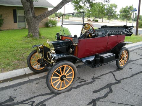 1914 Ford Model T - This 1914 Ford Model T Touring car features a black and red color scheme with wooden spoke wheels.