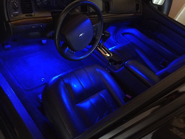 Car front footwells and seats lit with blue LED accent lighting at night