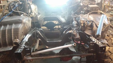 1995 Ford Bronco - The undercarriage of a vehicle, likely a truck or SUV, is shown with the engine and frame components visible. The frame and some engine par…