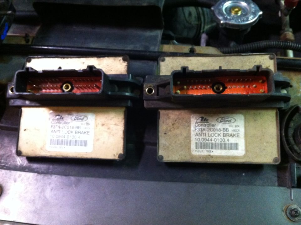 Two Ford Anti Lock Brake controllers with visible orange circuit boards.