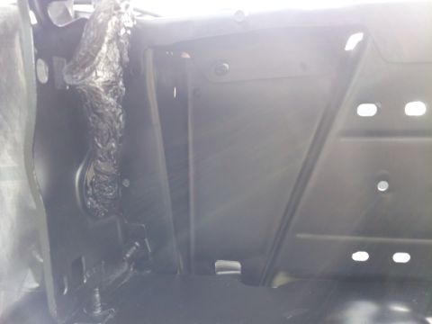 1976 Ford Ranchero - This is a close-up shot of the interior of a vehicle, possibly a Ford Ranchero, showing a black metal panel with some wiring covered in pro…