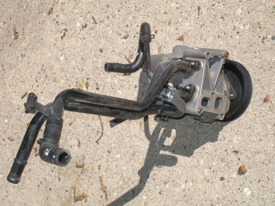 Vehicle water pump and hoses on concrete