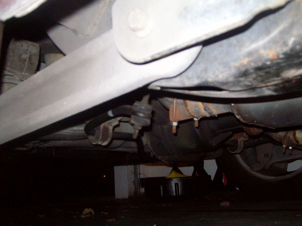 Underside of a vehicle showing rear differential and sway bar