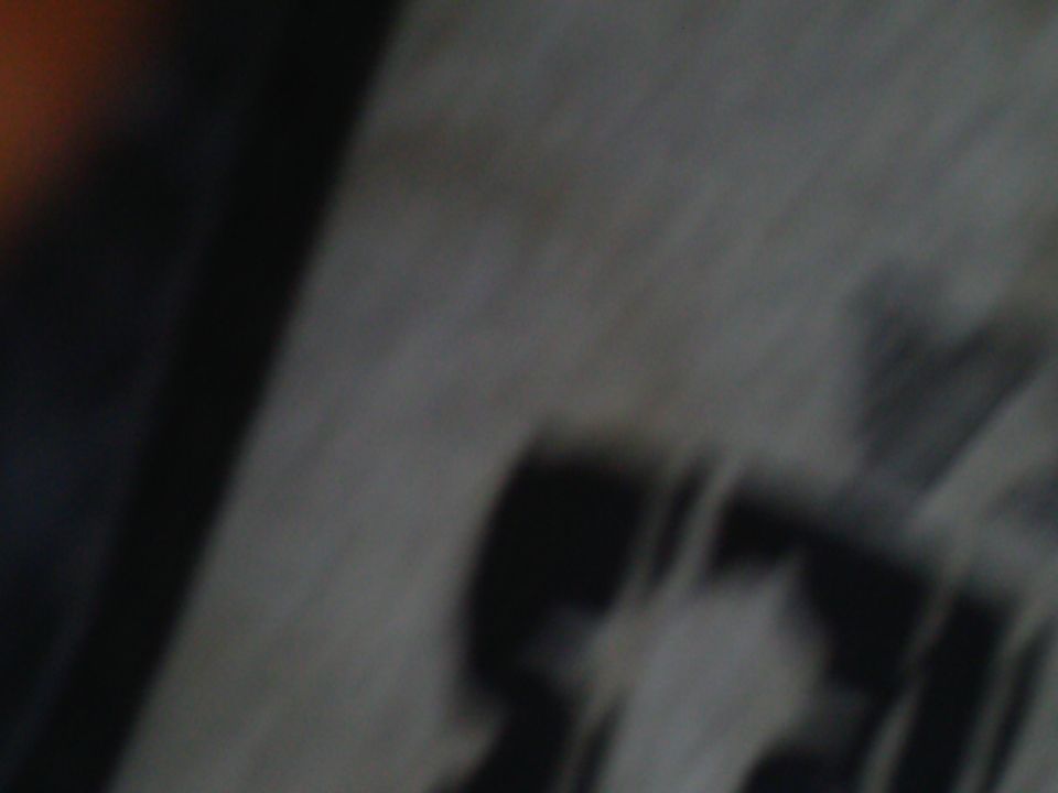 Blurry close-up of a vehicle exterior with a diagonal stripe.