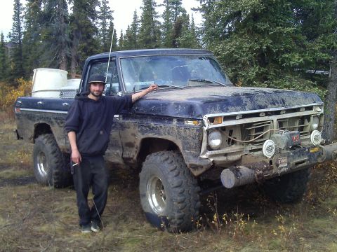 1990 Ford F-250 - This vintage Ford truck, likely from the 1970s, is heavily muddied and equipped with a front-mounted winch.
