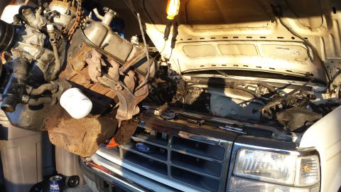 1995 Ford Bronco - The engine is being removed from a Ford truck, likely for repair or replacement.