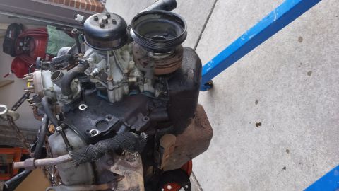 1995 Ford Bronco - A V8 engine is shown on an engine stand, possibly removed for repair or replacement.