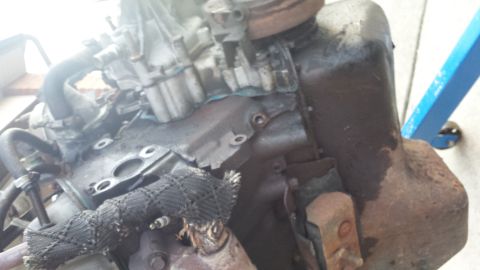 1995 Ford Bronco - Close-up of an engine block and exhaust manifold, with a Supermotors.net logo in the corner.