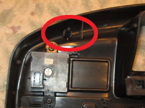 1990 Ford Bronco - Close-up of a vehicle's headlight switch assembly, with a red circle highlighting a black knob.