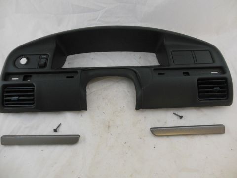 1990 Ford Bronco - This is a dashboard trim piece, likely for a car's instrument cluster area. It includes air vents and openings for switches.