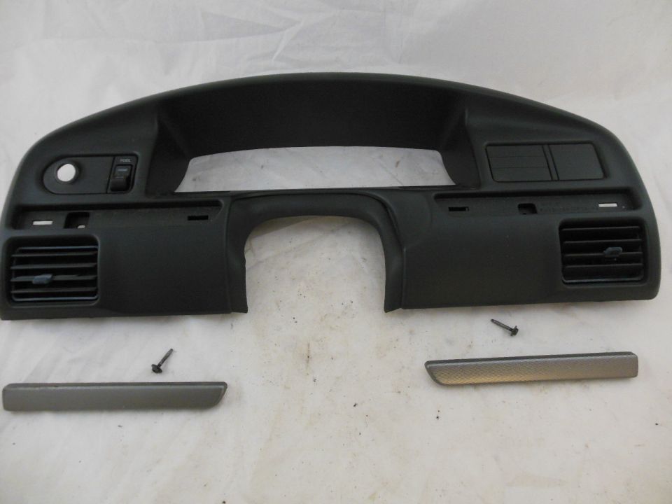 Dashboard trim piece with vents and switch openings. Two trim strips and screws are separate
