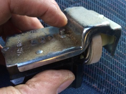 1990 Ford Bronco - A close-up view of a vehicle's headlight switch, showing internal components and markings.