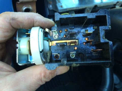 1990 Ford Bronco - Close-up of a vehicle's headlight switch assembly, revealing its internal electrical components and connections.
