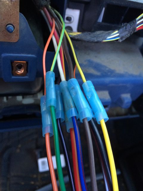1990 Ford Bronco - Close-up view of a wiring harness with multiple colored wires connected by blue crimp connectors.