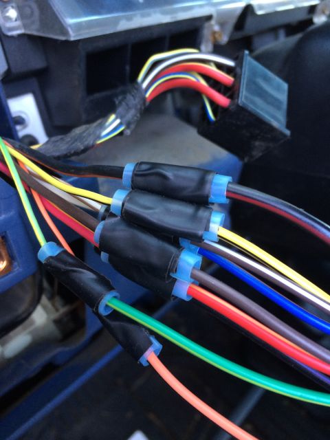 1990 Ford Bronco - A close-up view shows a complex automotive wiring harness with various colored wires neatly connected.