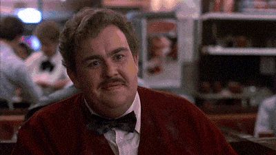 2000 Mercury Grand Marquis - A man wearing a red jacket and bow tie is seen in what appears to be a diner or restaurant setting.
