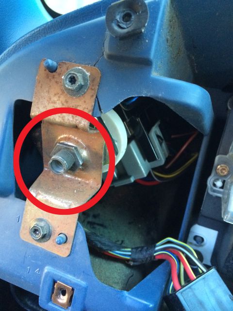 1990 Ford Bronco - Close-up of a vehicle's headlight switch mounting bracket, showing its internal components and wiring.