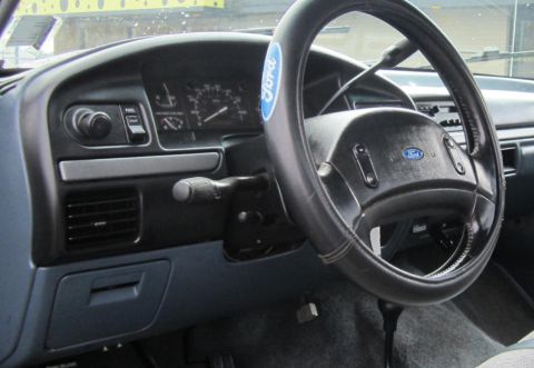 1990 Ford Bronco - Interior view of a Ford truck, focusing on the dashboard and steering wheel area.