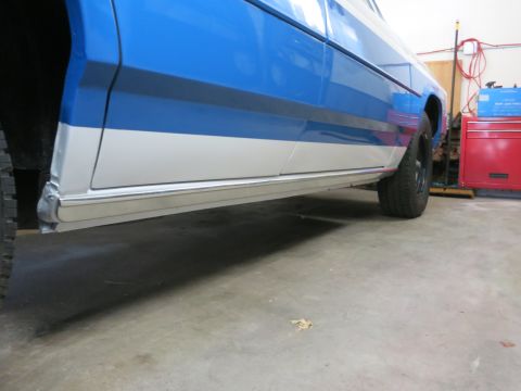 1991 Ford LTD Crown Victoria - Lower side panel and wheel of a 1991 Ford Crown Victoria LTD in a garage setting.