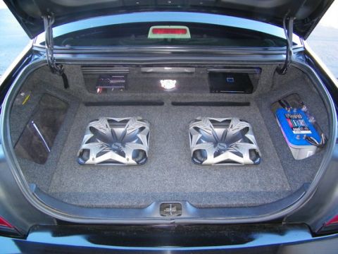 2007 Ford Crown Victoria - The trunk of a car is outfitted with a custom audio system, including subwoofers and amplifiers.