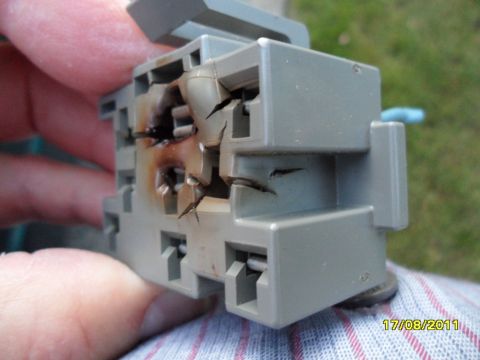 1990 Ford Bronco - Close-up of a damaged electrical connector showing signs of melting and cracking.