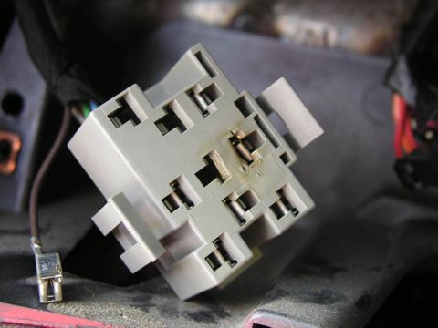 1990 Ford Bronco - A close-up view of a damaged electrical connector with visible signs of burning.