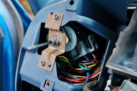 1990 Ford Bronco - The intricate wiring harness and mechanical components of a vehicle's headlight switch are visible.