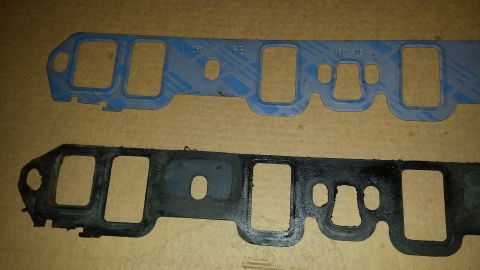 1995 Ford Bronco - Comparison of a new blue intake gasket and an old, used black one.