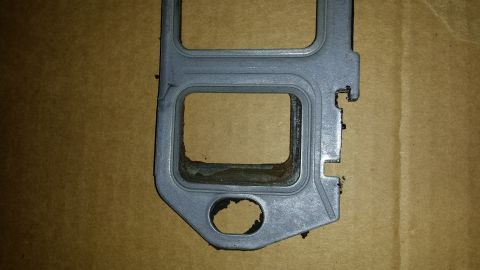 1995 Ford Bronco - Close-up of an engine gasket, showing its metallic construction and sealing edges.