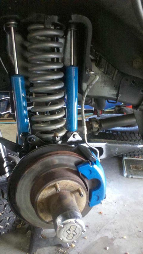1982 Ford Bronco - The front suspension and brake system of a vehicle are shown in this close-up view.
