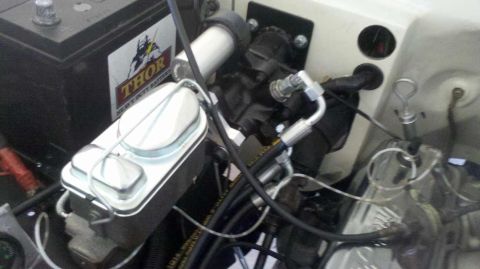 1982 Ford Bronco - Close-up view of the engine bay, the brake master cylinder and a Thor Heavy Duty Battery. The Supermotors.net logo is visible in the lower…
