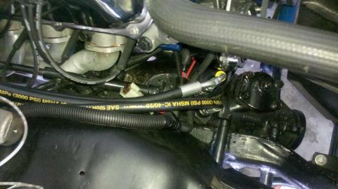 1982 Ford Bronco - Engine bay detail with hydraulic hoses and steering components visible. Some text is present on the hose.