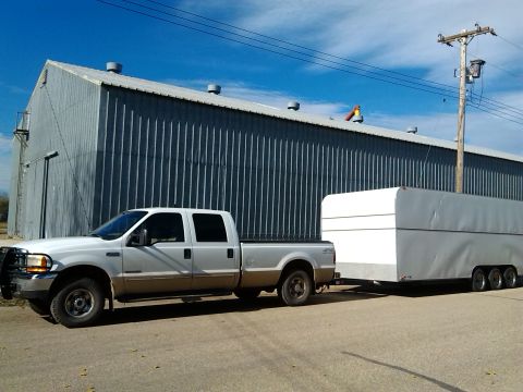 2000 Ford F-250 - 2000 Ford F-250 Super Duty pickup truck is seen towing a large white enclosed trailer.