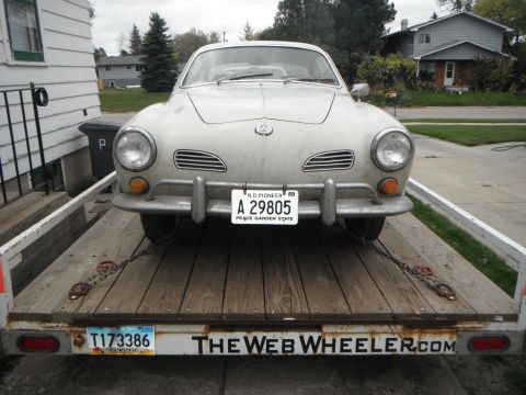 2000 Ford F-250 - A vintage Volkswagen Karmann Ghia is loaded onto a trailer, ready for transport.