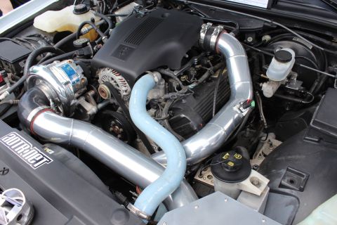 2004 Ford Crown Victoria - Custom supercharger installation in an engine bay, polished metal components and blue hoses.