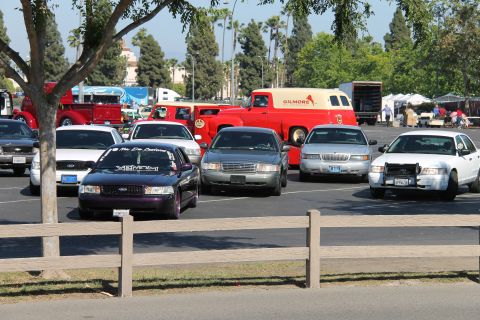 2004 Ford Crown Victoria - A collection of Ford Crown Victorias are gathered, with a police interceptor model prominently featured.