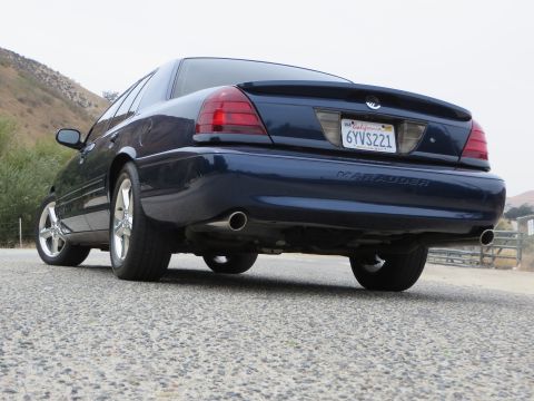 2003 Mercury Marauder - Rear view of a dark blue 2003 Mercury Marauder sedan parked on a gravel road.