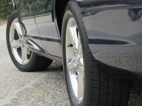 2003 Mercury Marauder - Side profile of a 2003 Mercury Marauder, highlighting its chrome wheels and dark paint.